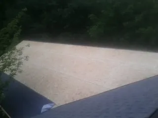 New OSB roof sheathing installed beside an existing shingle roof in Curtis Bay